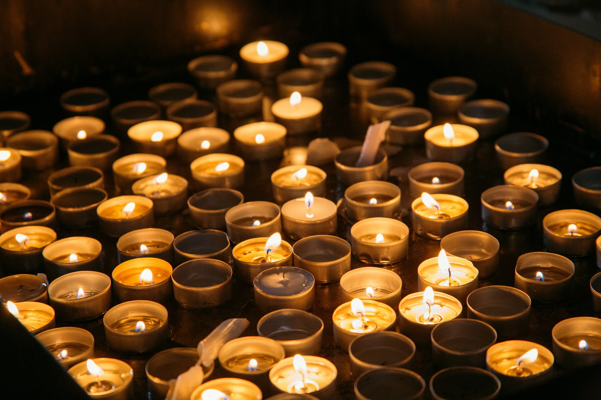 Candles lit in church. Warm light. Faith